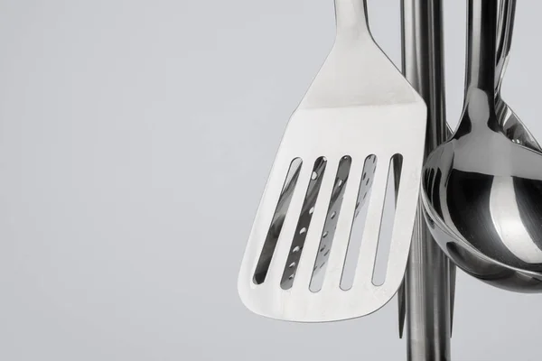 Support en aluminium avec ensemble d'ustensiles de cuisine sur fond blanc — Photo