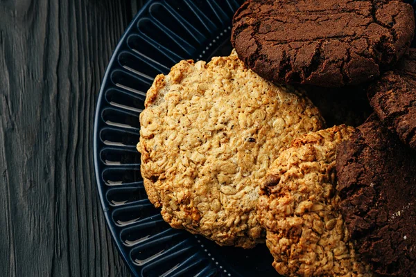 Biscoitos de chocolate e aveia na mesa de madeira escura — Fotografia de Stock