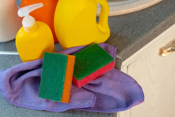 Cleaning detergents and tools on a kitchen counter — Stock Photo, Image