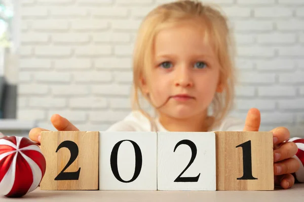 Toddler girl holding 2021 wooden cubes. Conceot of New Year 2021 — Stock Photo, Image