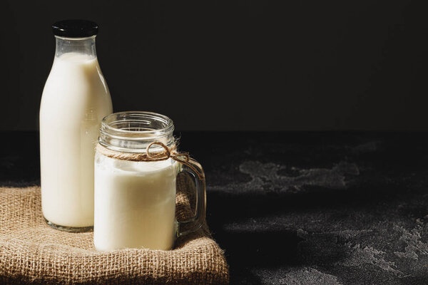 Bottle and glass of milk, front view