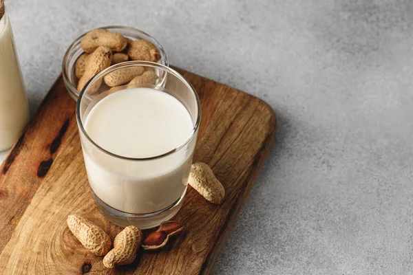 Vegan peanut milk in glass with peanuts