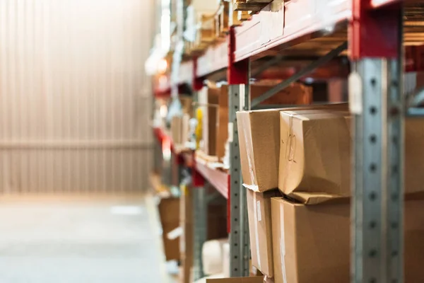 Modern warehouse shelves with pile of cardboard boxes