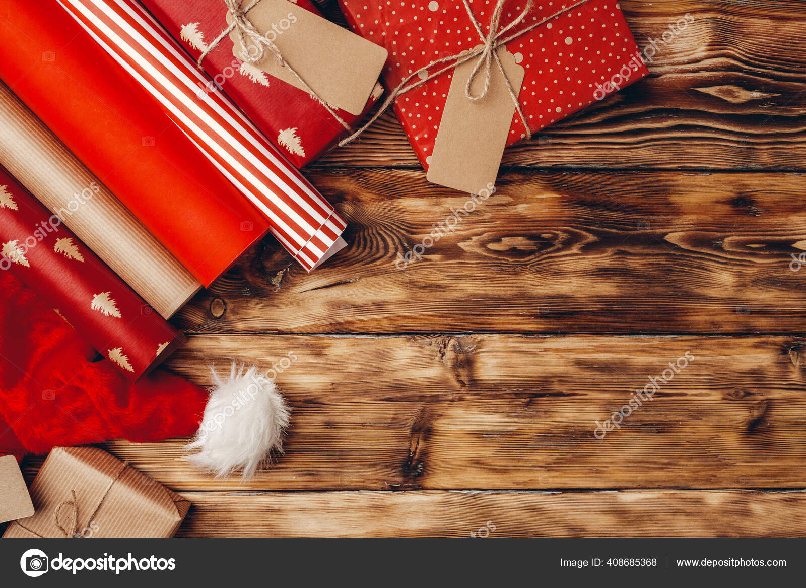 Wrapping paper rolls for Christmas gifts on brown wooden board Stock Photo  by ©Fotofabrika 408685368