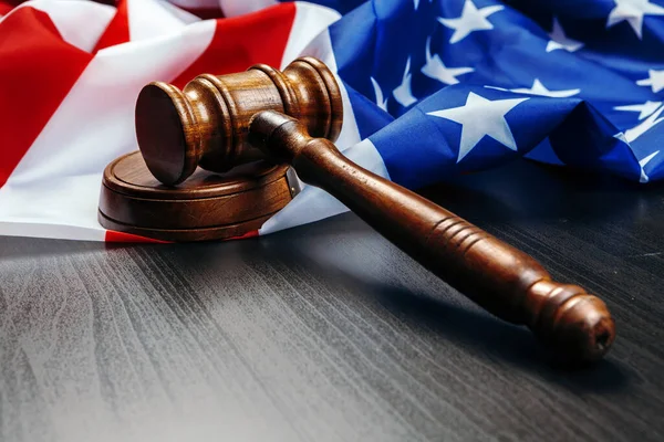 Gavel on wooden table with USA flag — Stock Photo, Image
