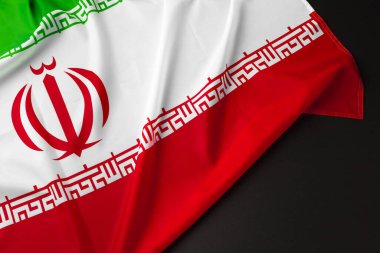 Photo of fabric flag of Iran close up clipart