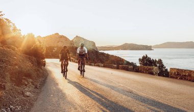 Sabahları bisiklete binen iki profesyonel erkek bisikletçi.