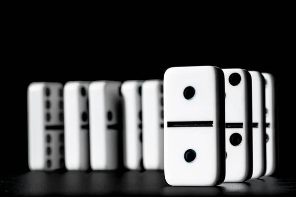 Dominoes standing in a row on black background — Stock Photo, Image