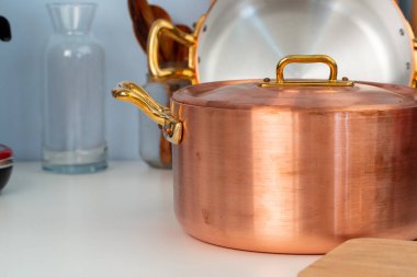 Temiz yemek takımları, modern mutfaktaki masaları kaplayan aletler.