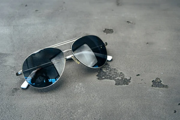 New dark aviator glasses on grey concrete background — Stock Photo, Image