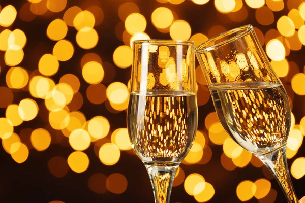 Two glasses of Champagne against bokeh lights background — Stock Photo, Image