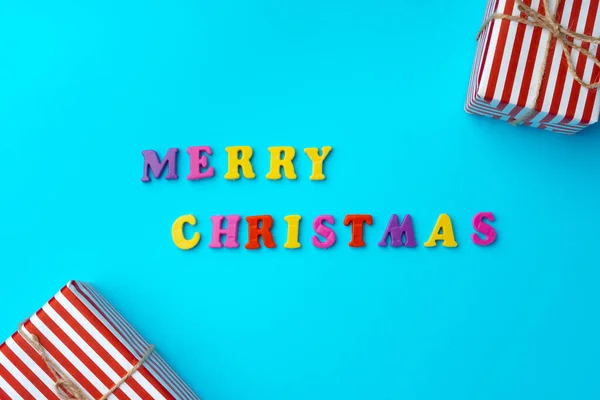 Words Merry Christmas on blue background top view — Stock Photo, Image