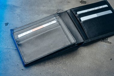Gri beton arka planda siyah deri cüzdan