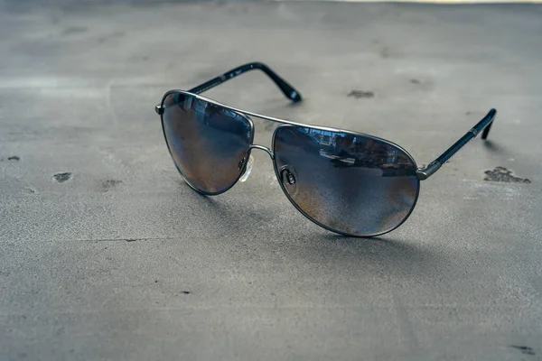 New dark aviator glasses on grey concrete background — Stock Photo, Image