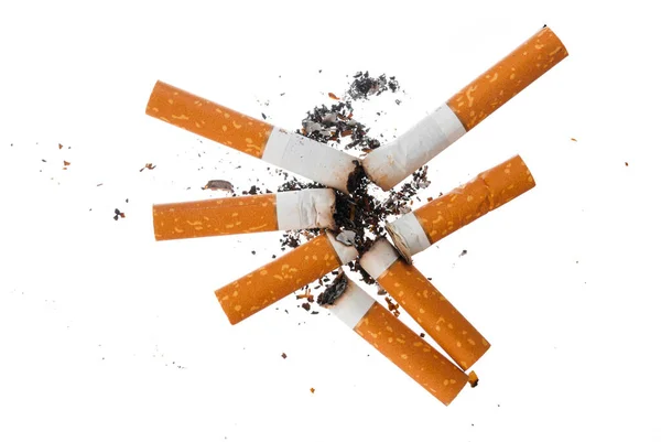 Pile of extinguished cigarette butts isolated on white — Stock Photo, Image