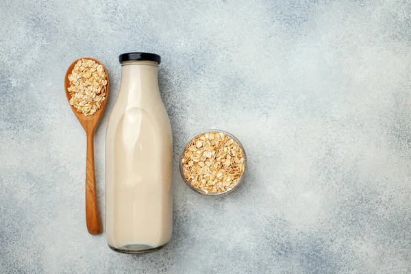 Non dairy oat milk and oat flakes in bowl