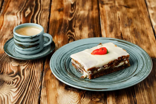 Slice of carrot cake on green plate