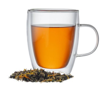 Bir bardak çay ve kuru çay yaprakları beyaz üzerine izole edilmiş.