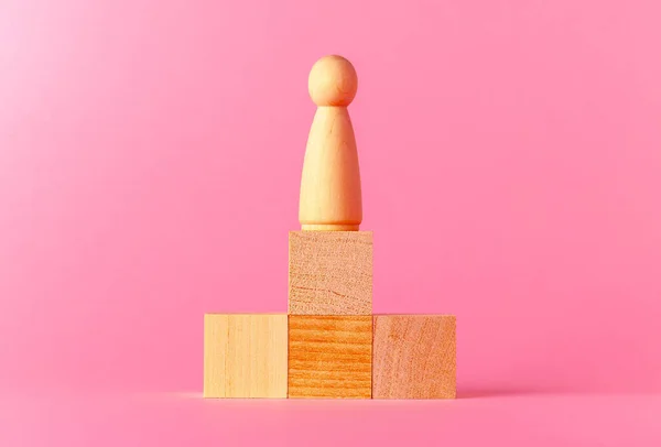 Toy wooden cubes with copy space against pink background
