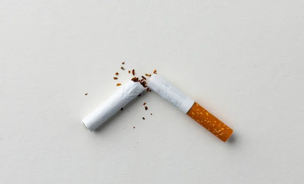 Kaputte Zigarette auf weißem Hintergrund von oben — Stockfoto