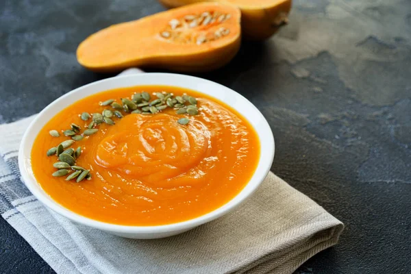 Homemade pumpkin soup on a black table — Stock Photo, Image