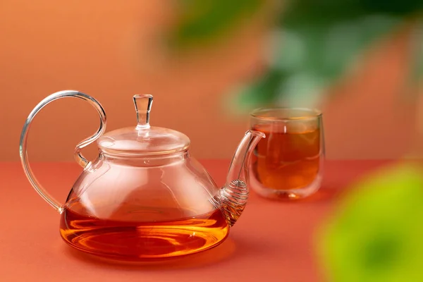 Glass teapot and cup with black tea — Stock Photo, Image