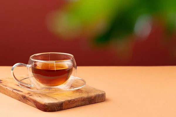 Copa de vidrio de té negro sobre mesa beige — Foto de Stock