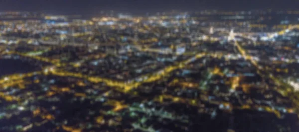 Blurred city lights bokeh. Aerial view urban night light bokeh.