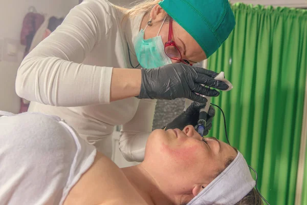 美容師は 女性の顔のニードル メソセラピー治療を実行します — ストック写真