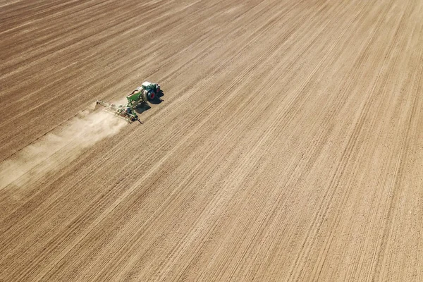 Aerial Tractor sowing crops at field