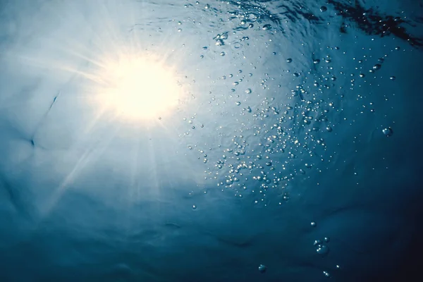 Underwater view of the water surface. Underwater background.