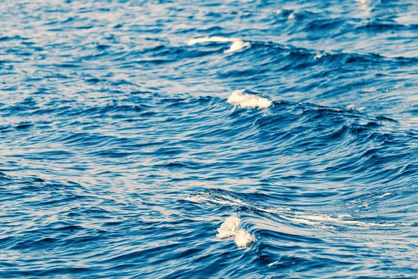 Waves behind a boat, Patterns of waves in water.