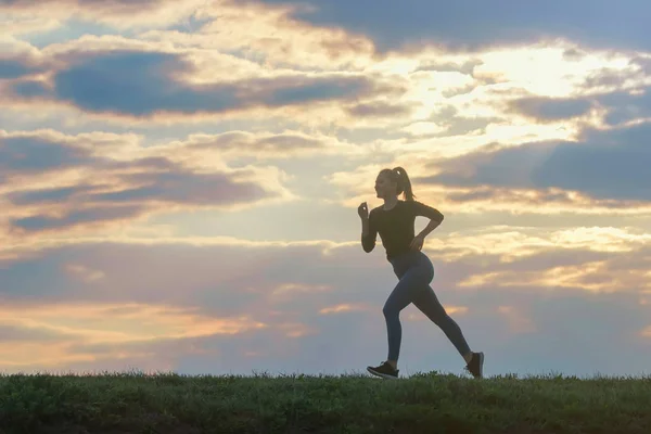 Running woman morning workout. Female Runner. Jogging during sun