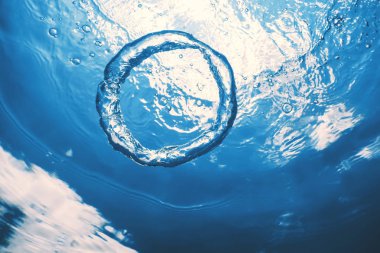 Bubble ring Underwater ascends towards the sun. clipart