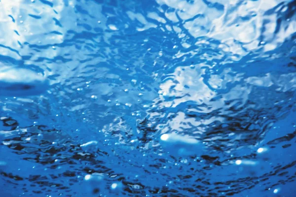 Underwater view of the water surface. Underwater background.