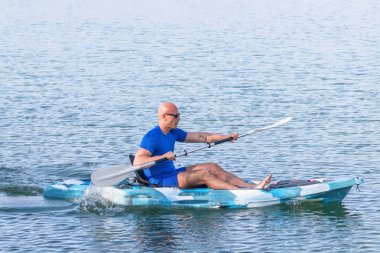 Genç kano kürek çeken kano. Sporcu, Blue Water 'da kayak yapıyor..
