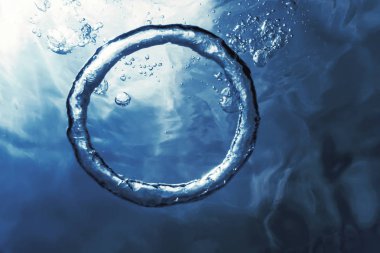 Bubble ring Underwater ascends towards the sun. clipart