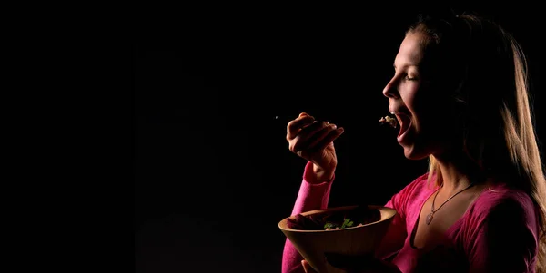 Female eat raw vegan healthy food. Raw food concept  bamboo bowl