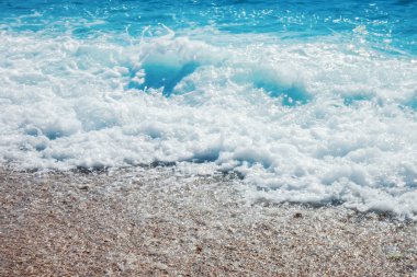 Kumlu kumsalda Mavi Okyanus Dalgası Yaz Arkaplanı