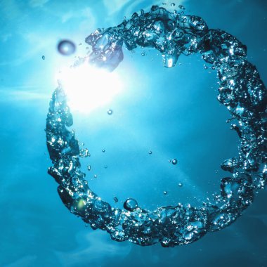 Bubble ring Underwater ascends towards the sun. clipart