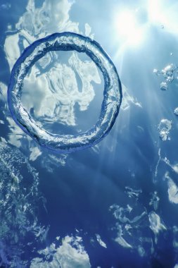 Bubble Ring Underwater ascends towards the Sun. clipart