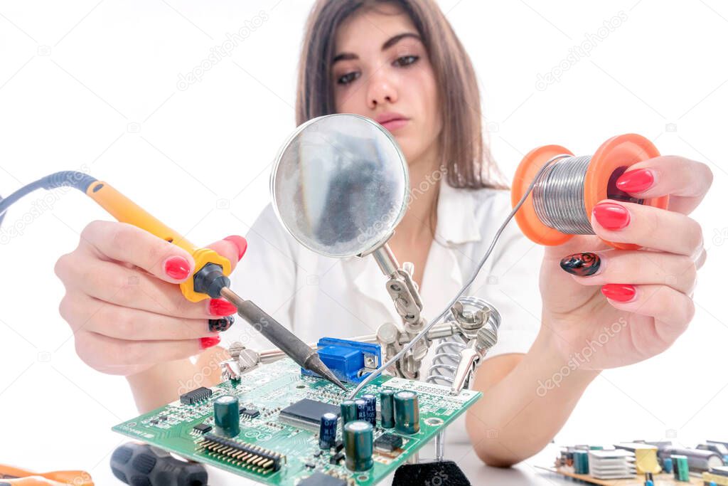 Woman Electronic Technician Repair Electronic Equipment using Electric Soldering Iron