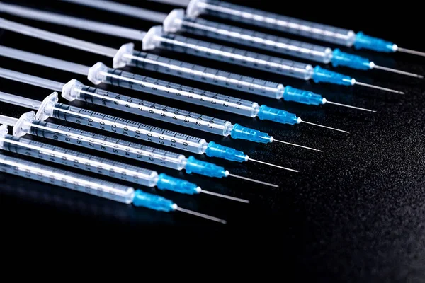 Medical Syringes Needle on Black Background, Close up Syringe, Health care concept