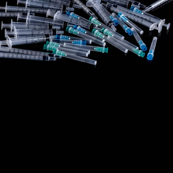 Medical Sterile Syringes Needles, Close up Syringes on Black Background, Health care concept. 