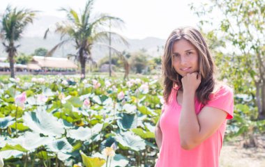 Genç kız kalın lotus gölet ve gülümseme