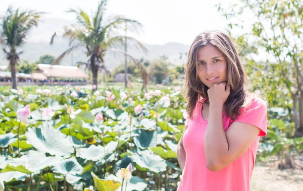 Genç kız kalın lotus gölet ve gülümseme