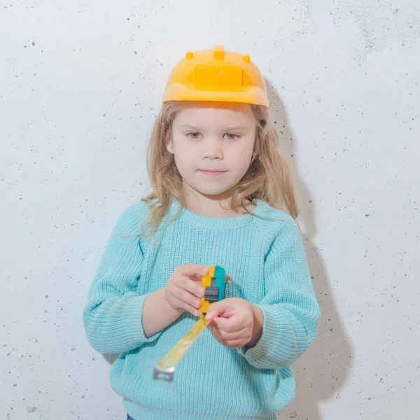 建筑工人 戴头盔的女孩用卷尺测量距离 — 图库照片