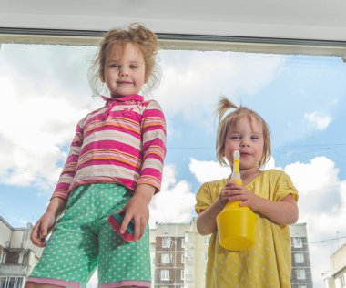 Kız, Pencere pervazı bir çocuğun pencerenin güneşli bir günde yıkar