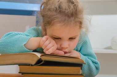 Kız, çocuk, ilkokul öğrencisi bir kitapla