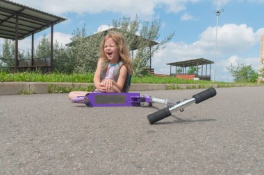 bir kız, bir çocuk bir Scooter'dan ve acı çığlık onun diz zarar